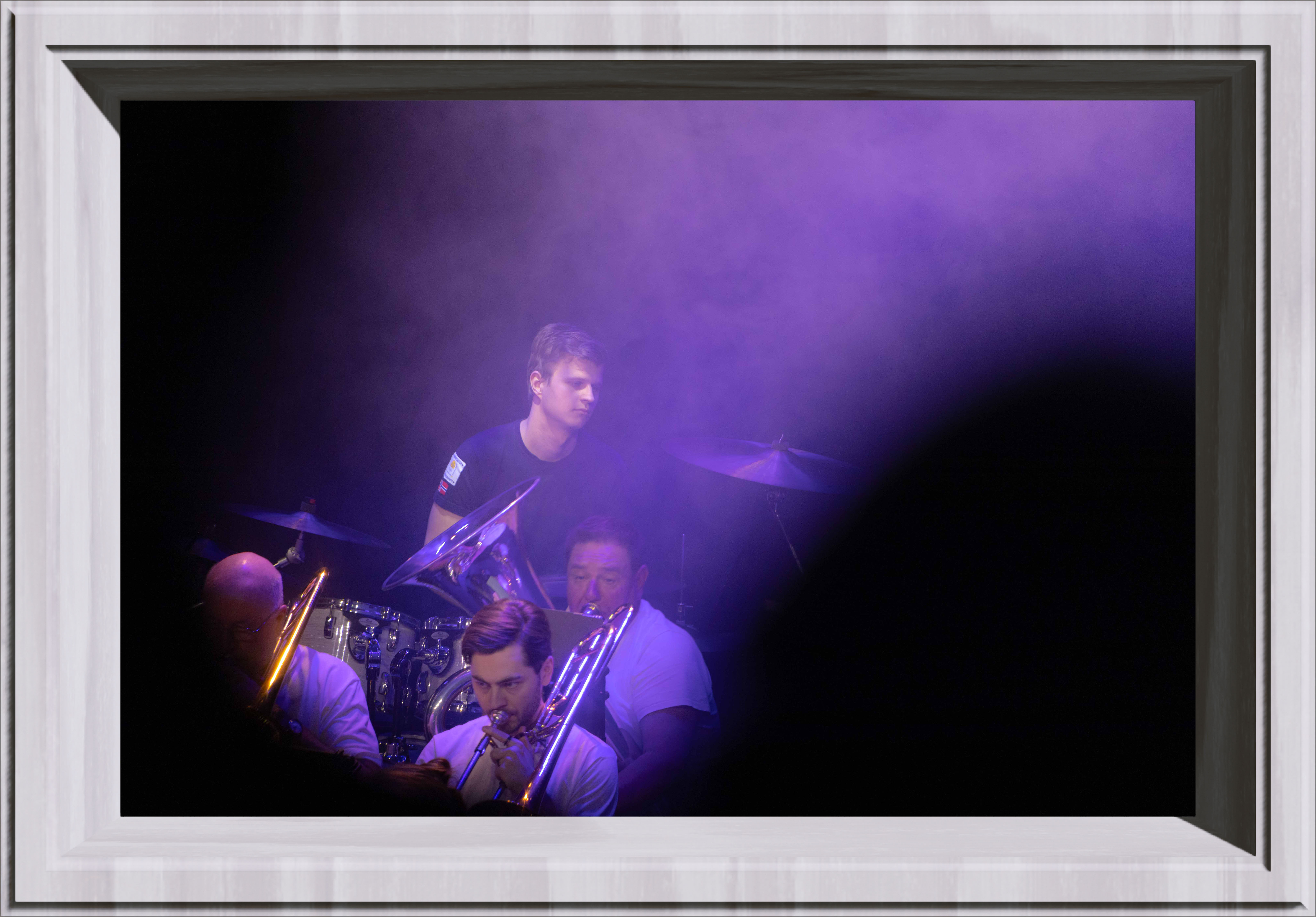 A drummer in purple light
