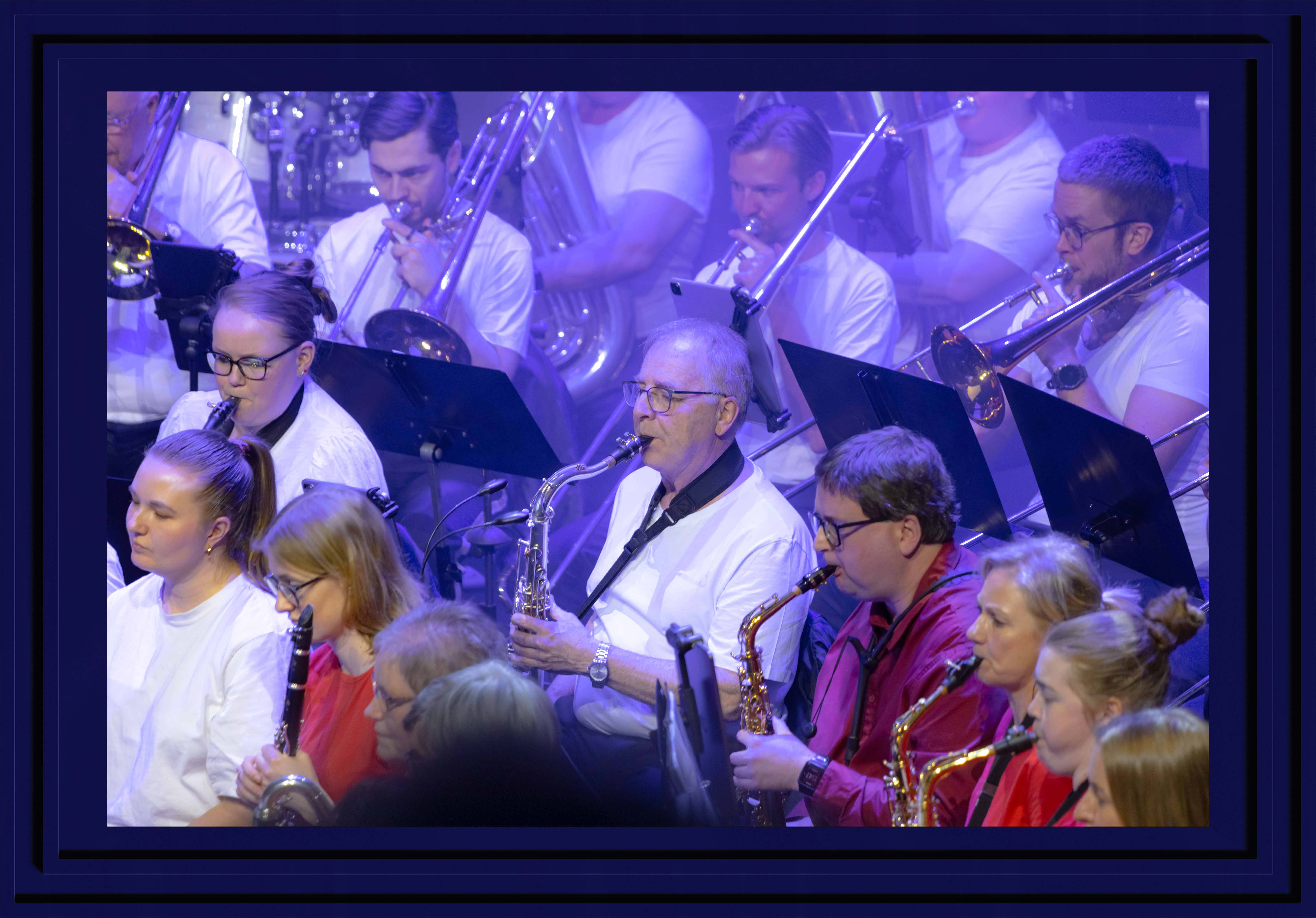 Saxophonists in purple light