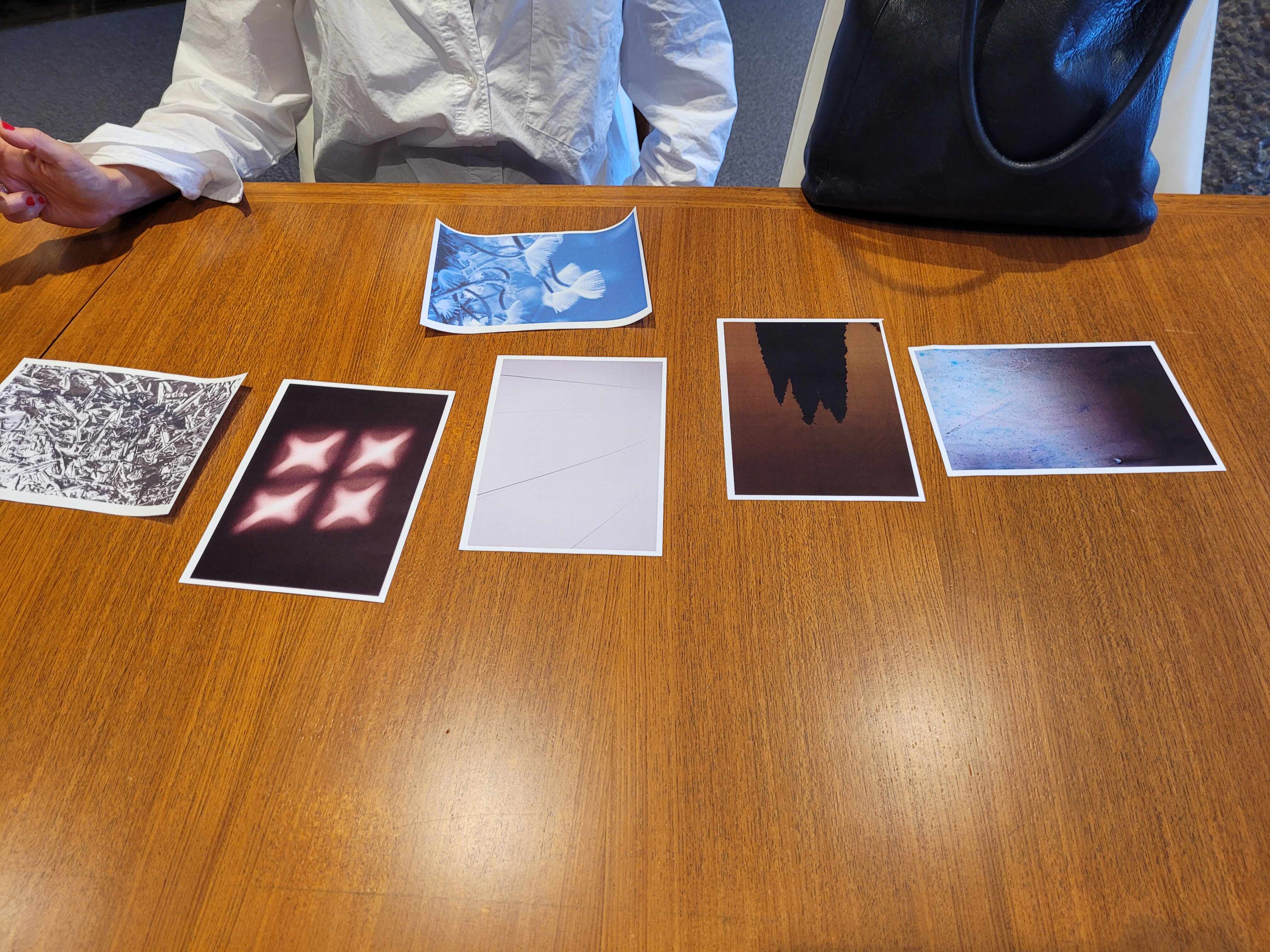 A selection of abstract photos on a wooden desk