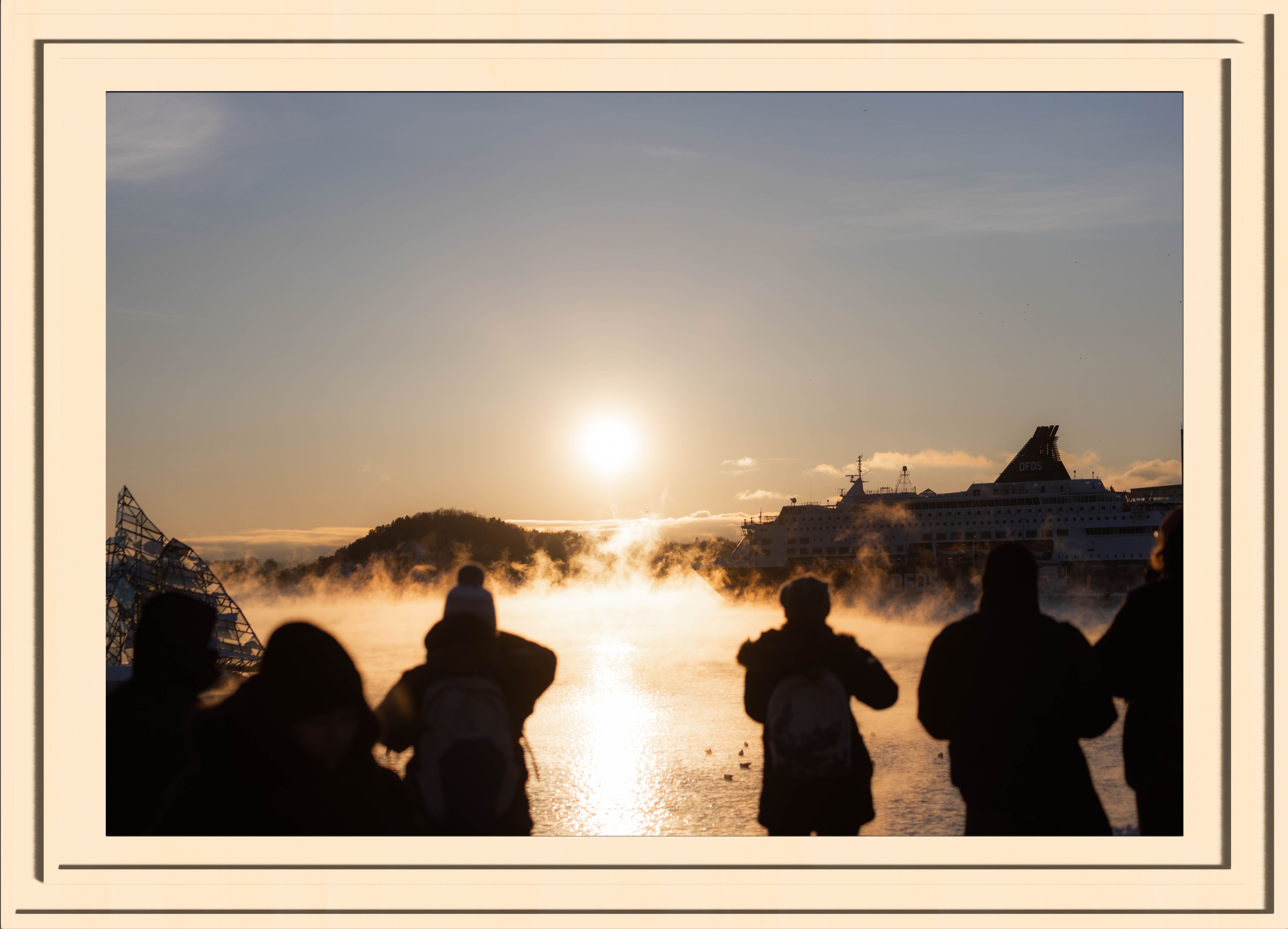 silhouettes of people taking pictures of the golden steam