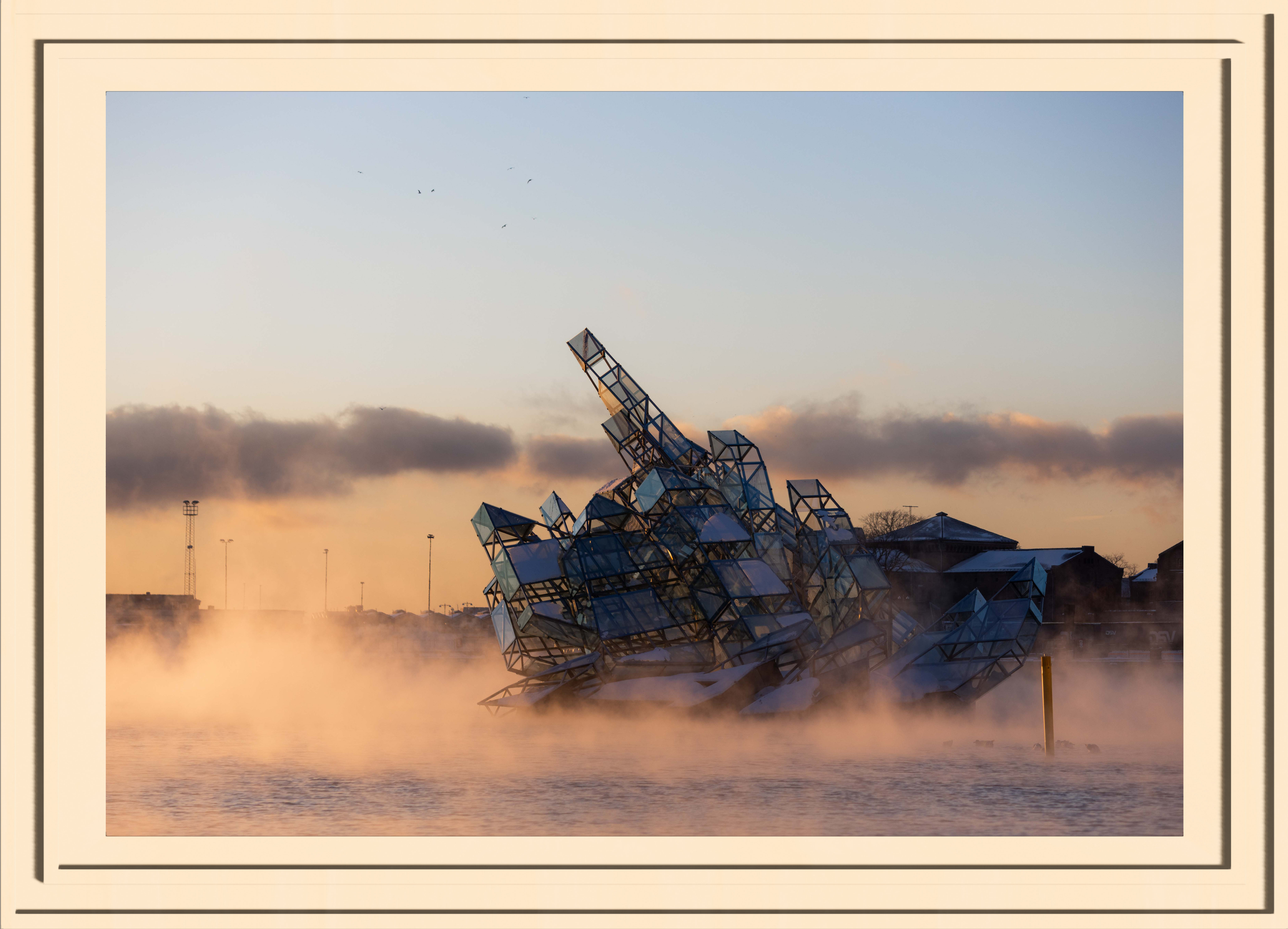 A glass sculpture surrounded in the golden steam