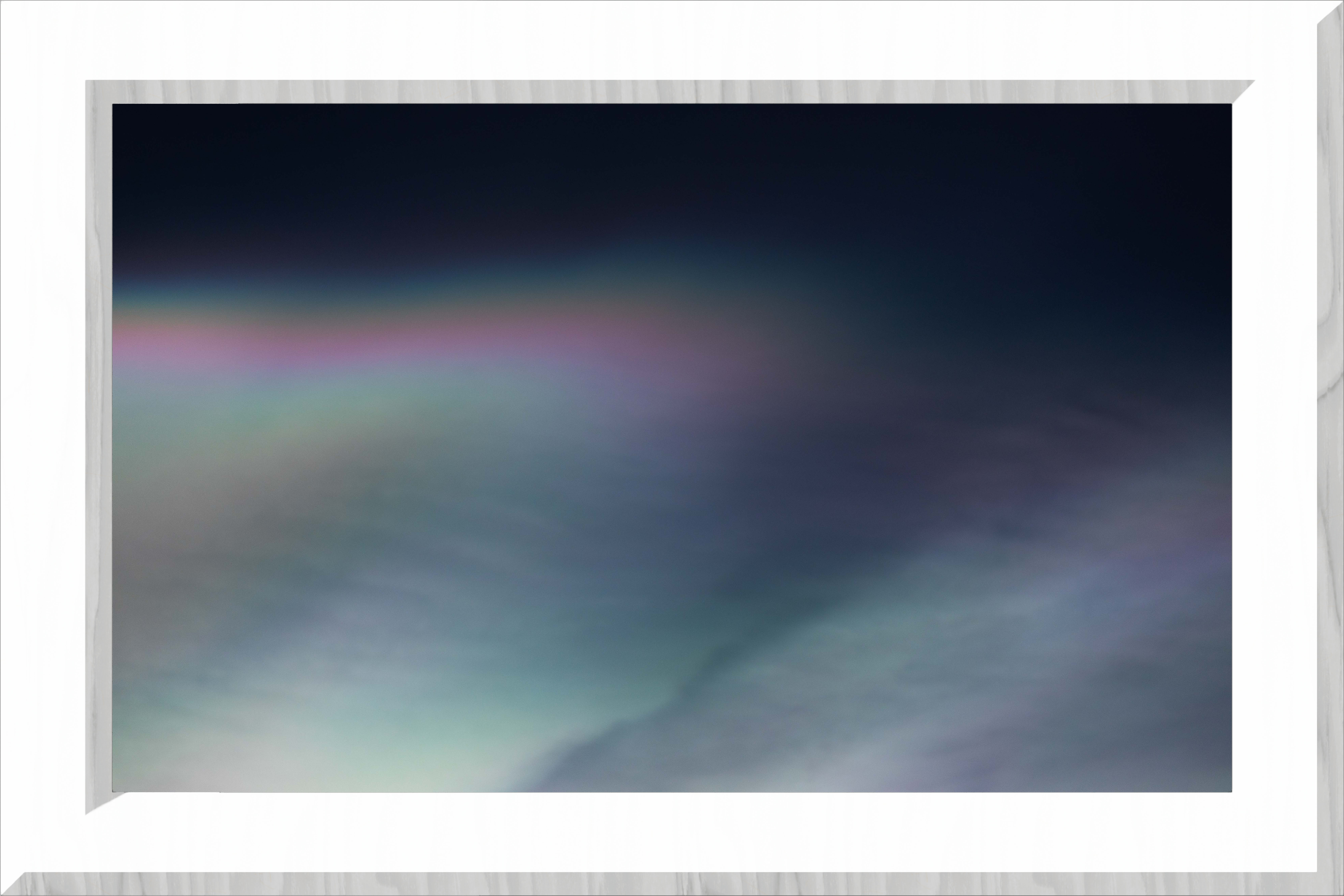 A smooth white cloud with a rainbow edge, ina white frame
