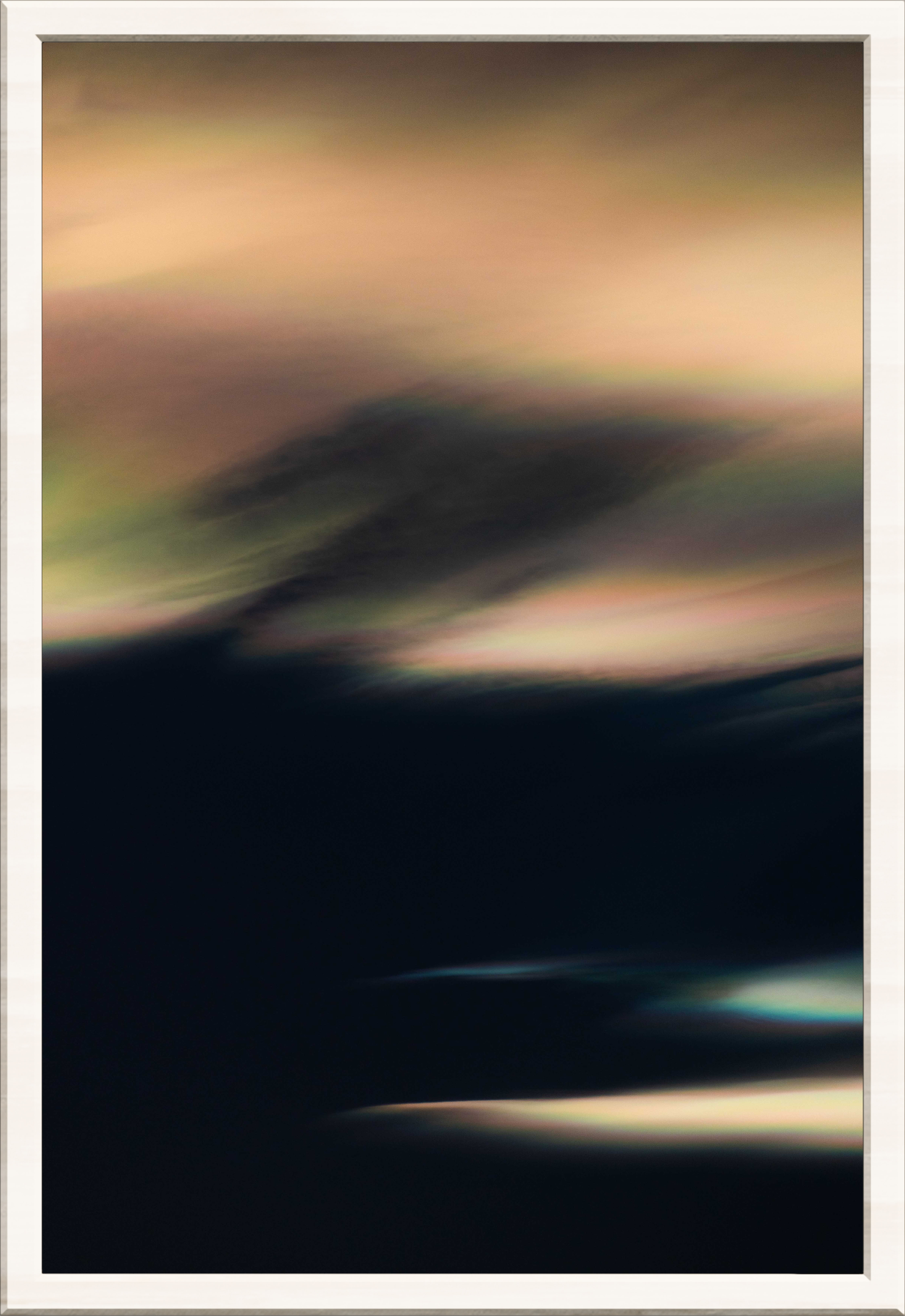 Iridescent Clouds in a dark sky that are silky and diffused, in a white frame