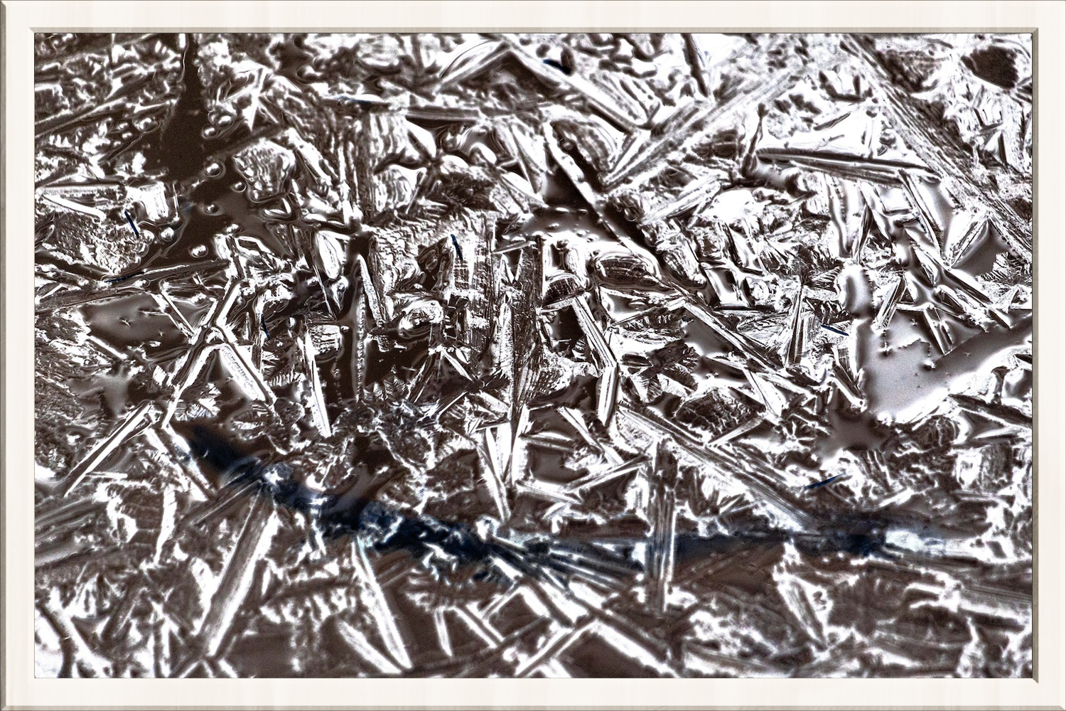 Negative image of crytallized ice framed in a thin white frame